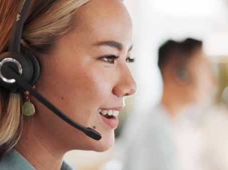 Call center, consulting and smile with woman in office for contact us, communication and customer service. Salesman, help desk and technical support with person in crm agency for telemarketing mockup